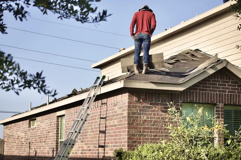 Professional roofer working on a residential roof in Vineyard Crossroads